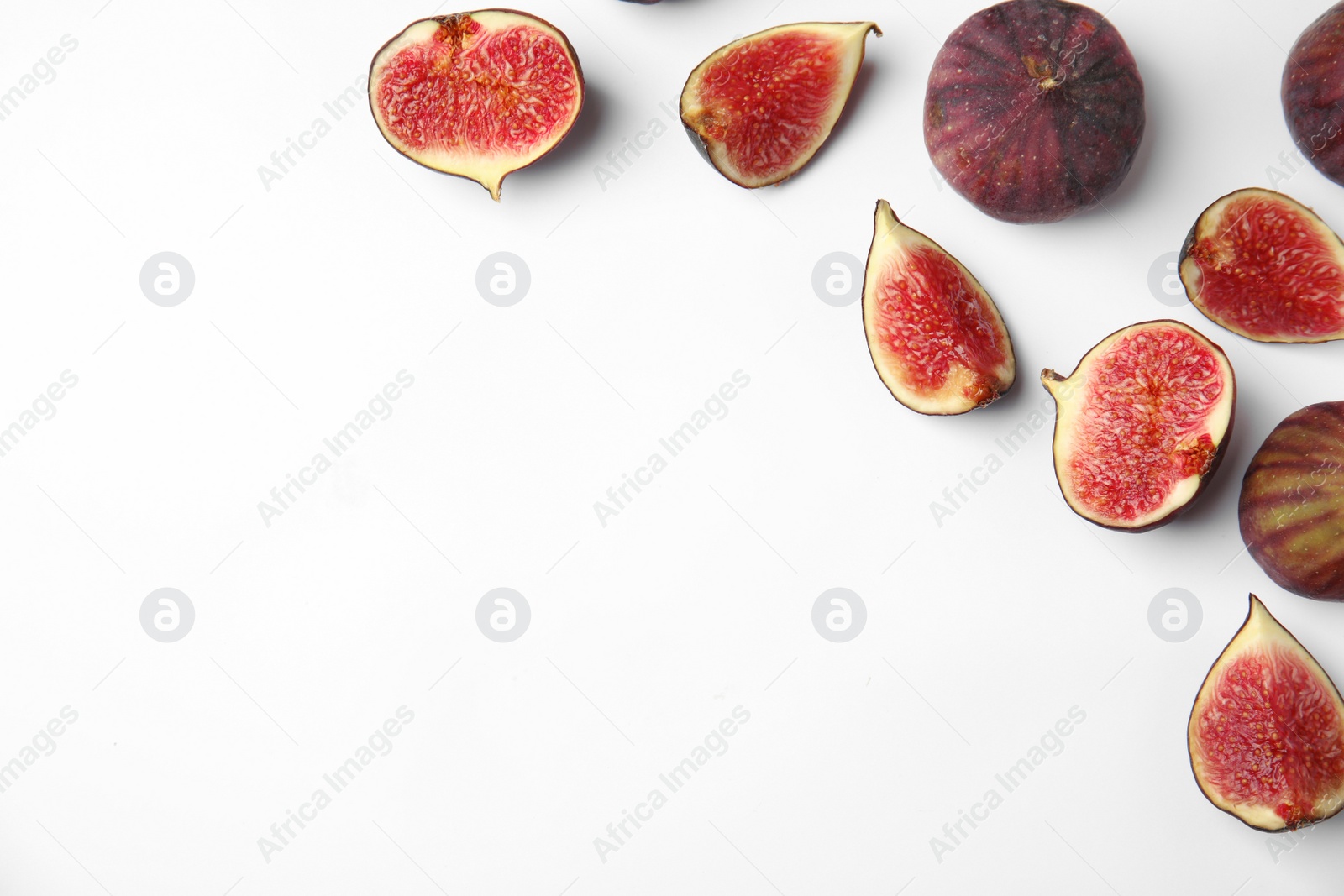 Photo of Tasty fresh fig fruits on white background, top view. Space for text