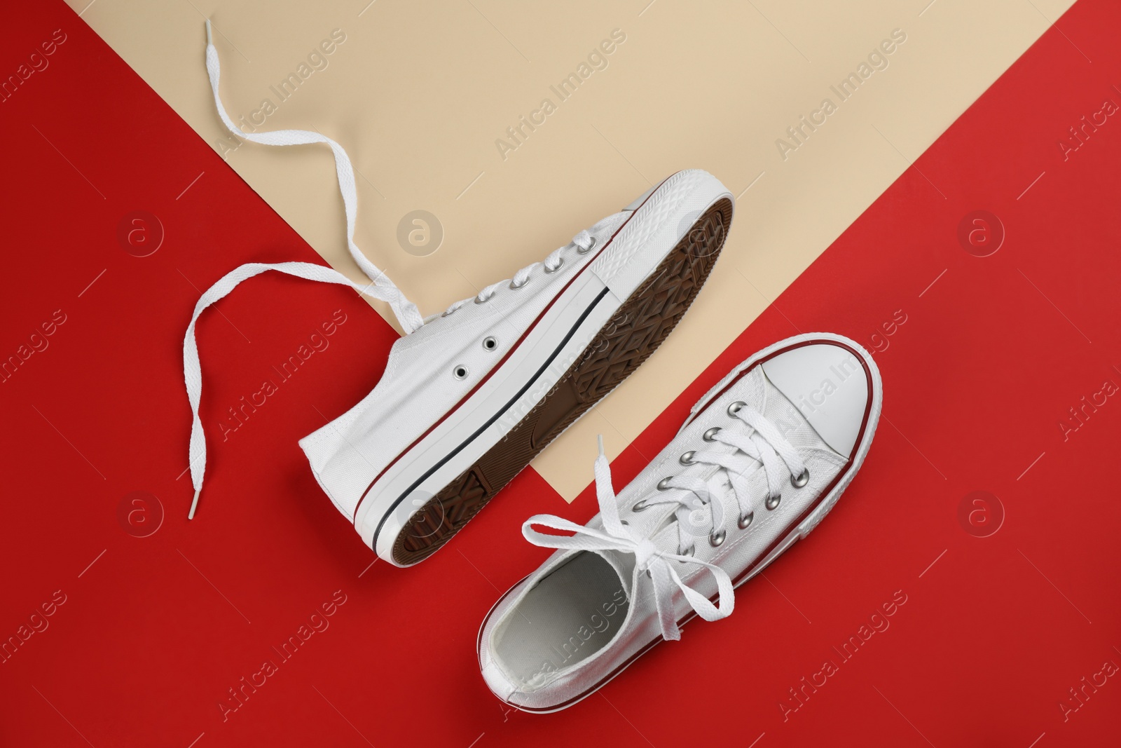 Photo of Stylish sneakers on color background, flat lay