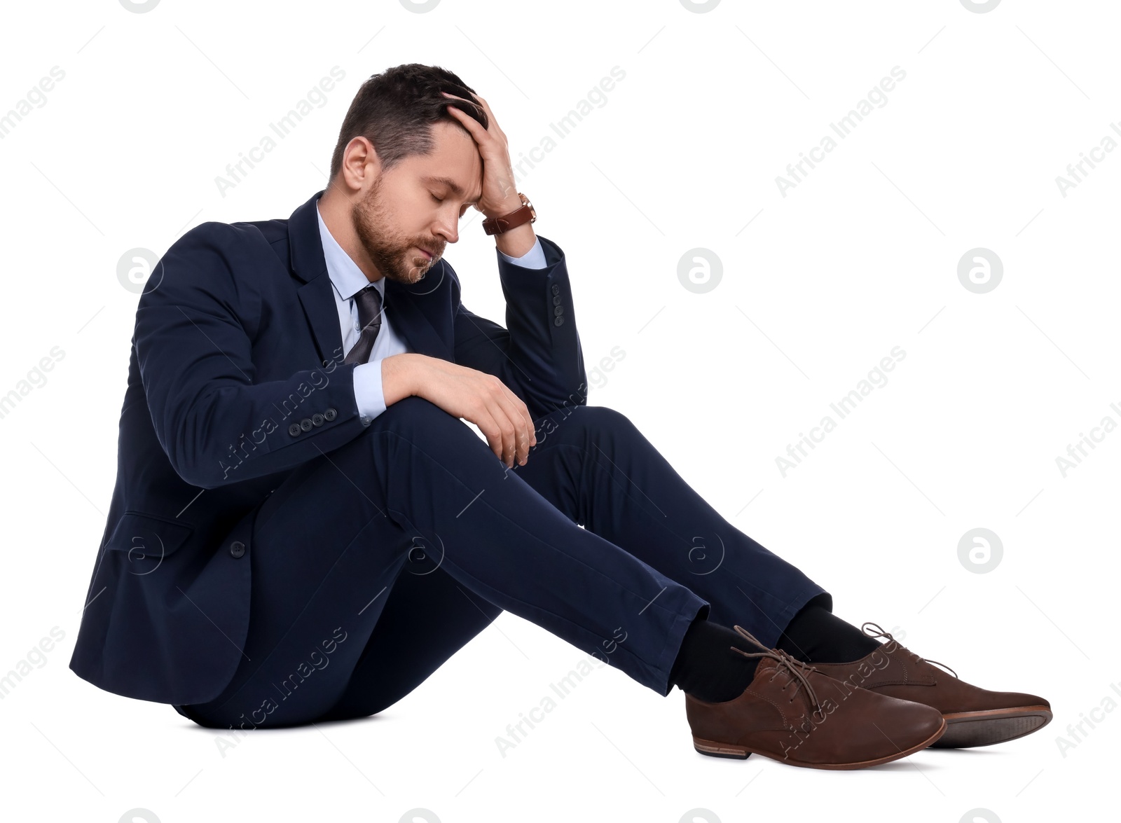 Photo of Upset bearded businessman in suit on white background