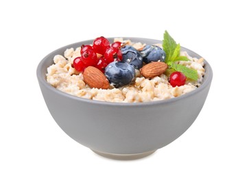 Ceramic bowl with oatmeal, berries. almonds and mint isolated on white