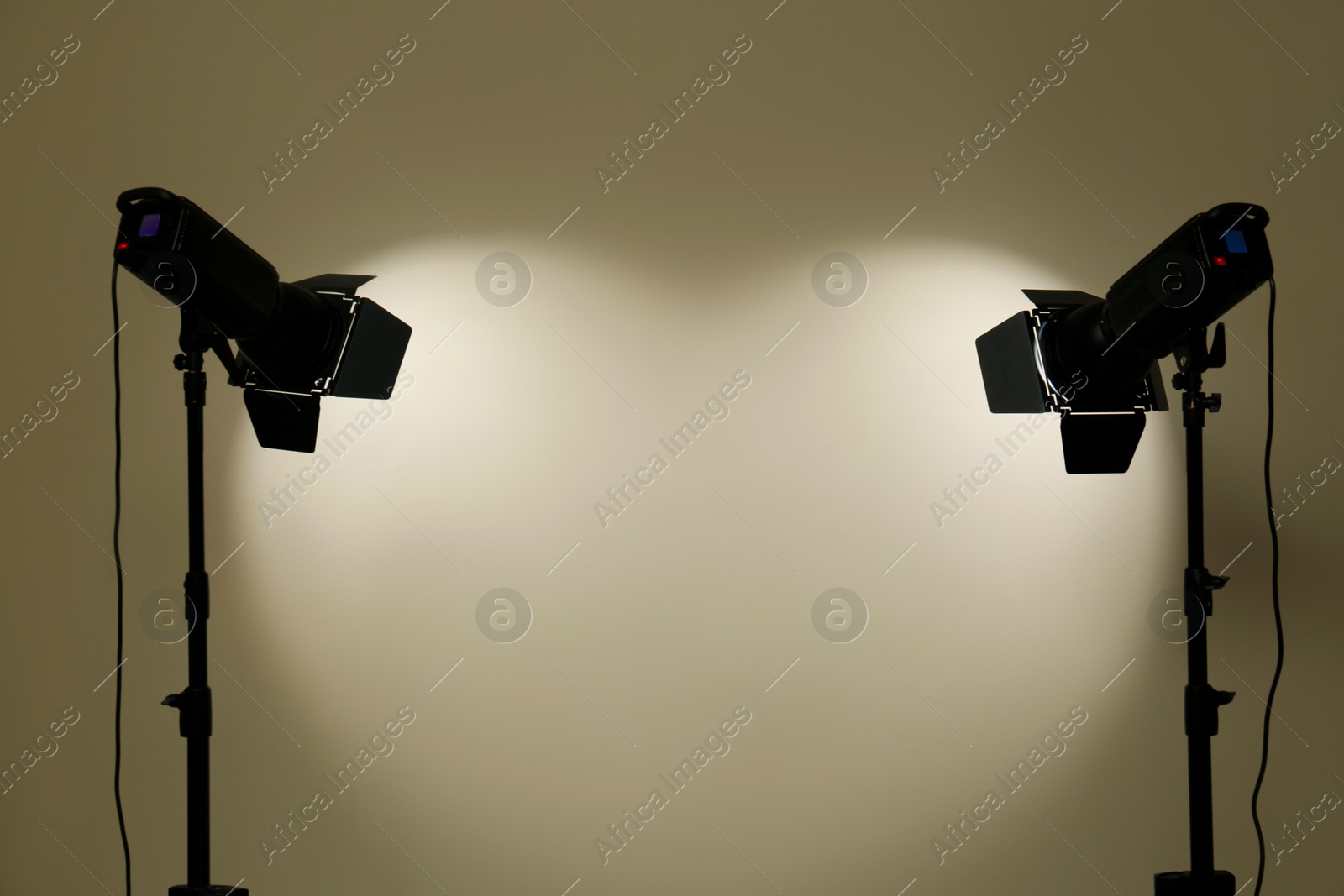 Photo of Modern spotlights against beige background, space for text