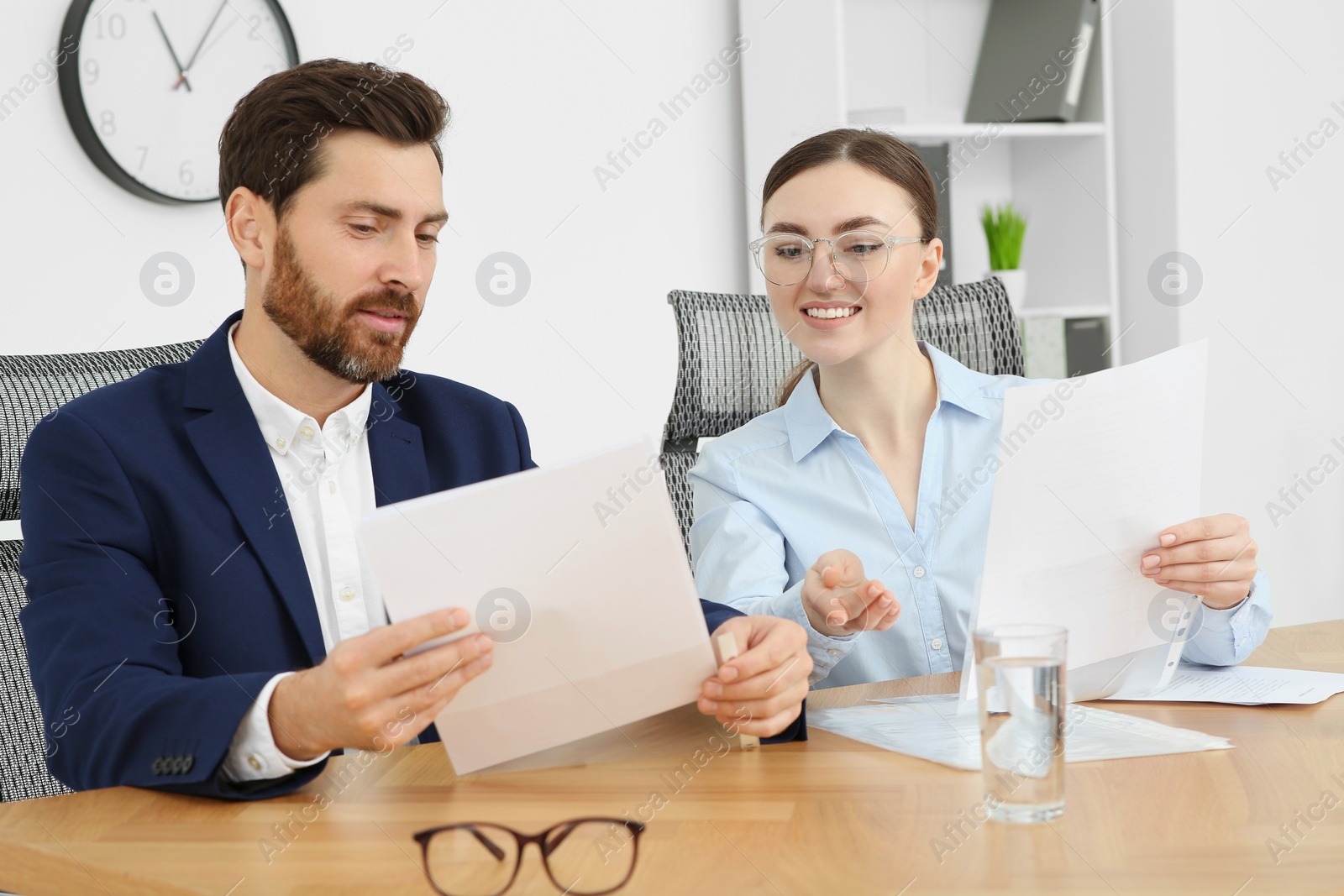 Photo of Businesspeople working together with documents in office