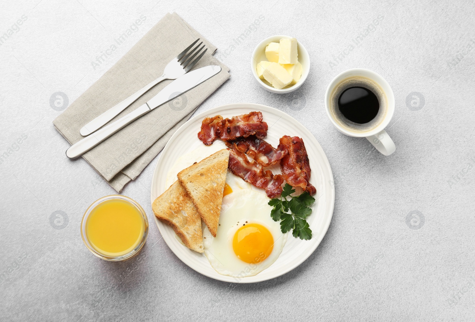 Photo of Delicious breakfast with sunny side up egg served on light table, flat lay