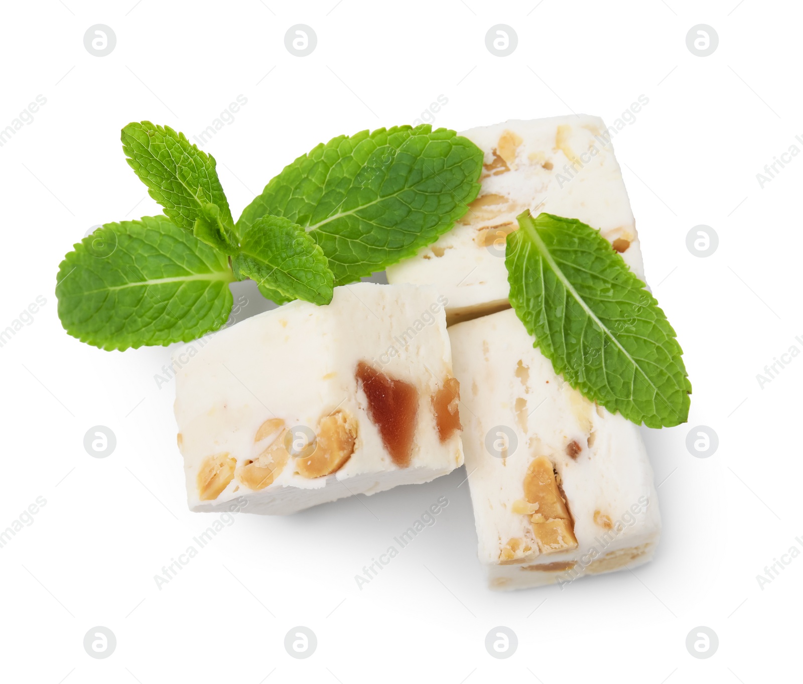 Photo of Pieces of delicious nougat and mint on white background, top view