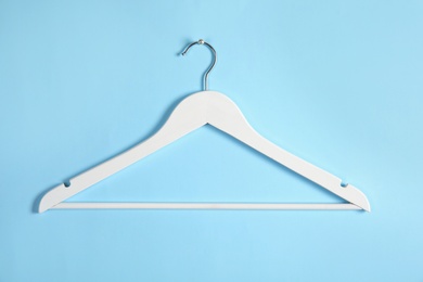 Photo of Empty clothes hanger on color background. Wardrobe accessory