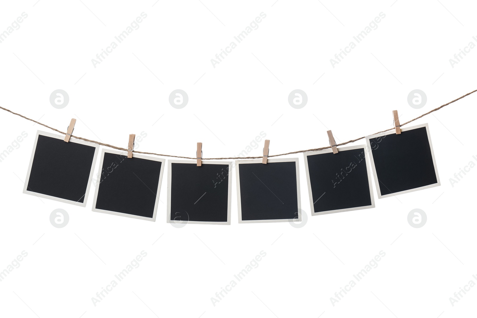 Photo of Clothespins with empty instant frames on string against white background. Space for text