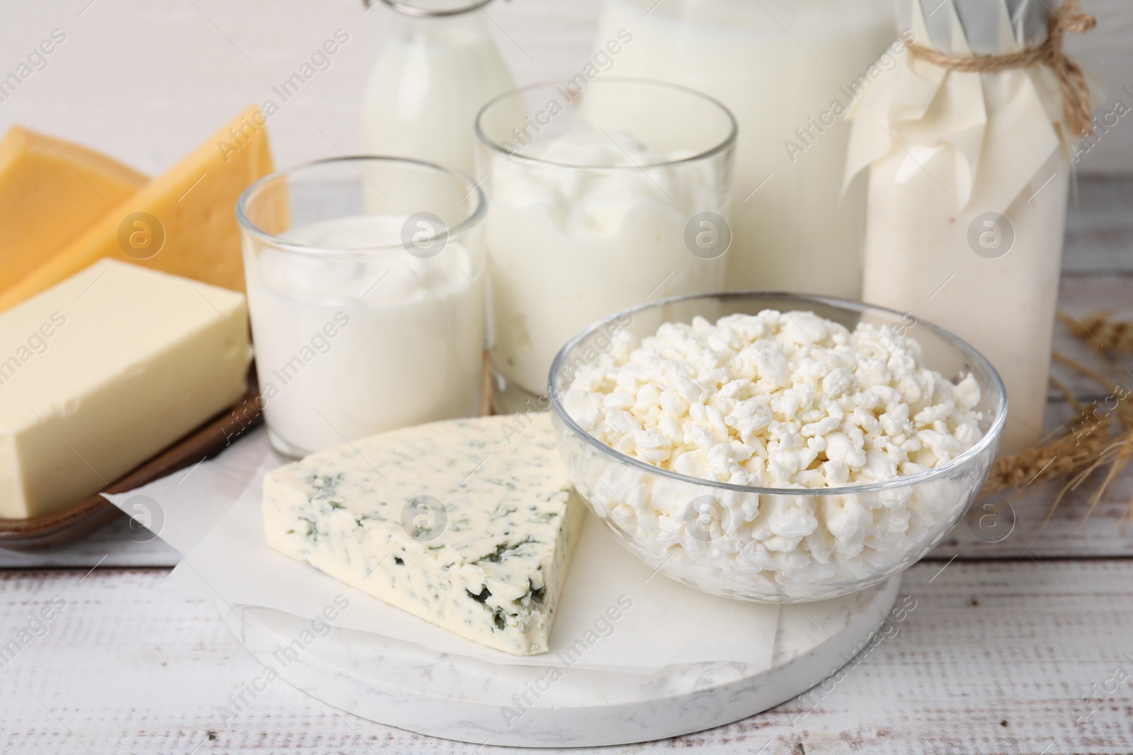 Photo of Different fresh dairy products on white wooden table