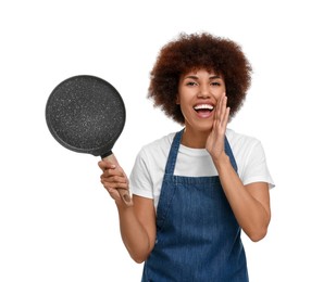 Emotional young woman in apron holding frying pan on white background