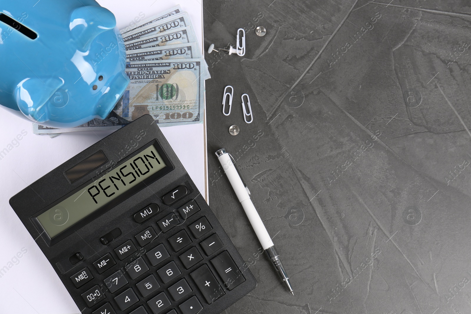 Image of Calculator with word Pension, piggy bank, money and stationery on grey table, top view. Space for text