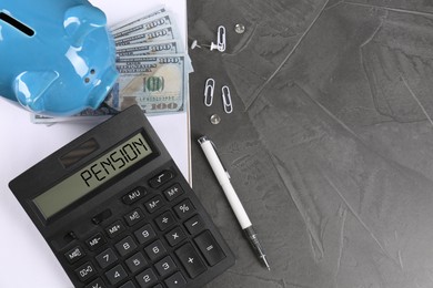 Calculator with word Pension, piggy bank, money and stationery on grey table, top view. Space for text