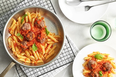 Photo of Pasta with meatballs and tomato sauce on light background