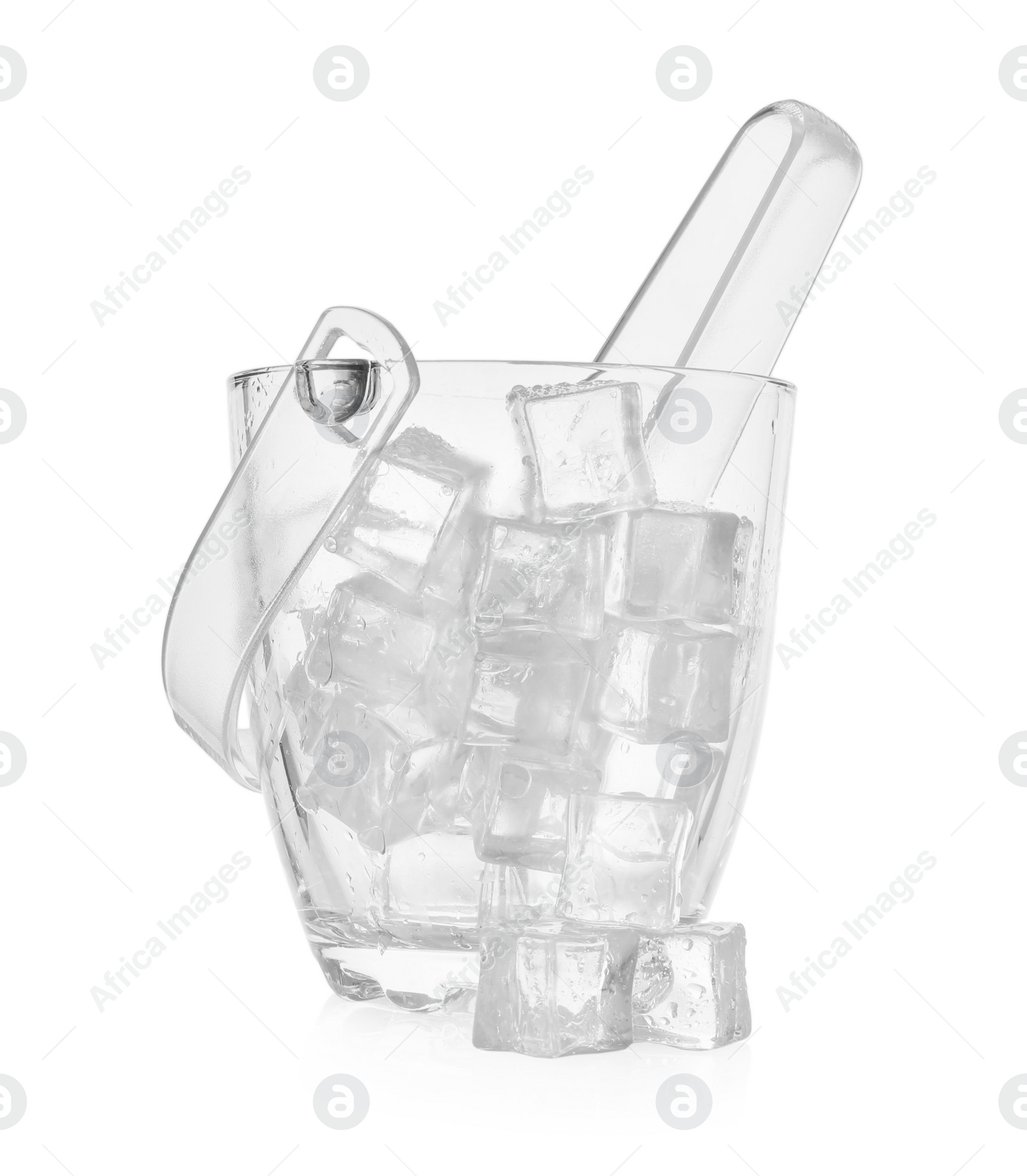 Photo of Glass bucket with ice cubes and tongs on white background