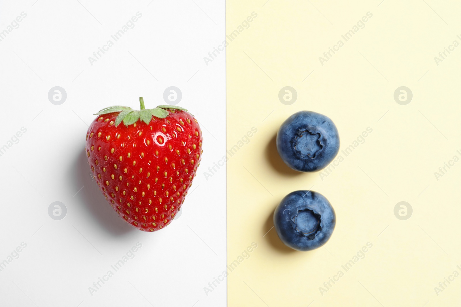 Photo of Flat lay composition with strawberry and blueberries on color background