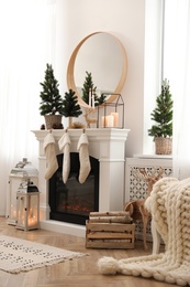 Fireplace in room with Christmas decorations. Interior design