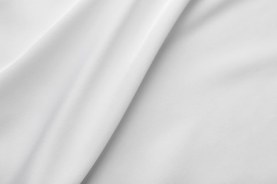 Photo of Texture of white silk ripple fabric as background, top view