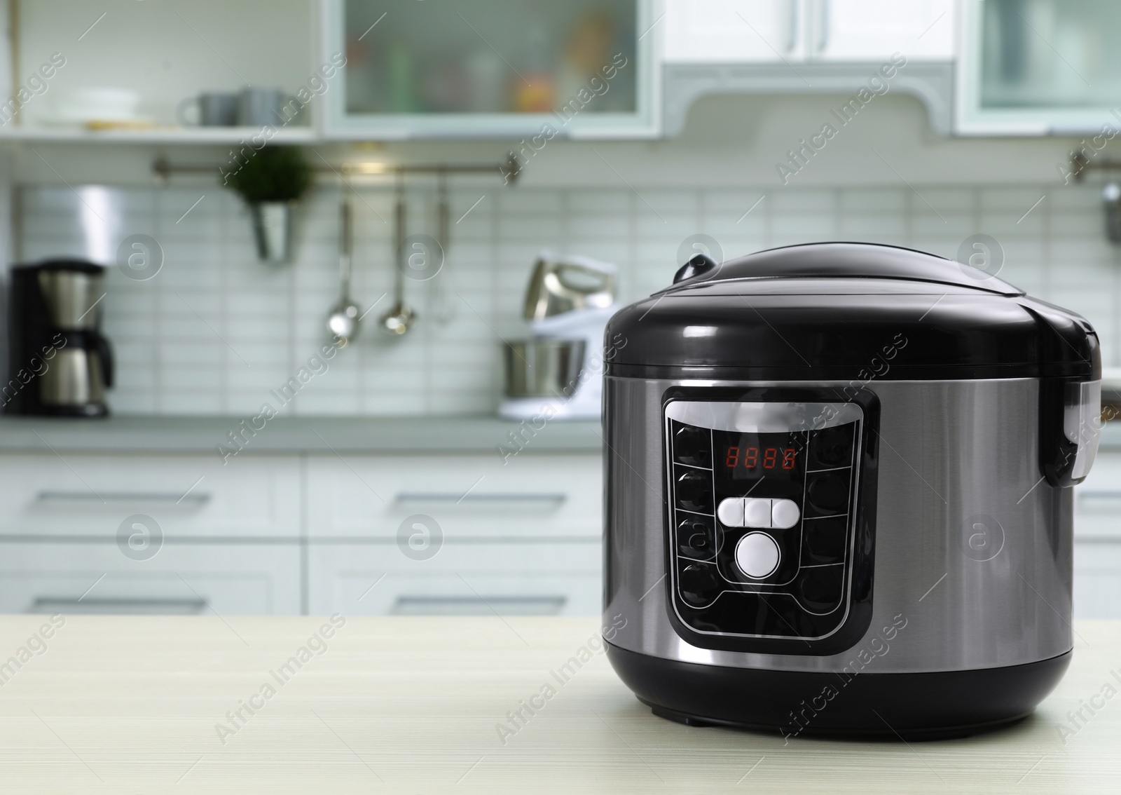 Photo of Modern multi cooker on table in kitchen. Space for text