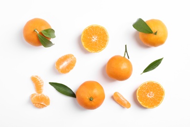 Photo of Composition with tangerines and leaves on white background, top view