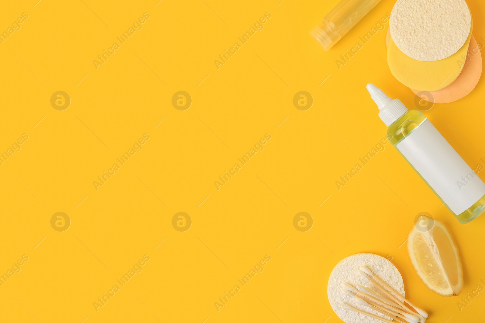 Photo of Lemon face cleanser. Fresh citrus fruits and personal care products on yellow background, flat lay with space for text