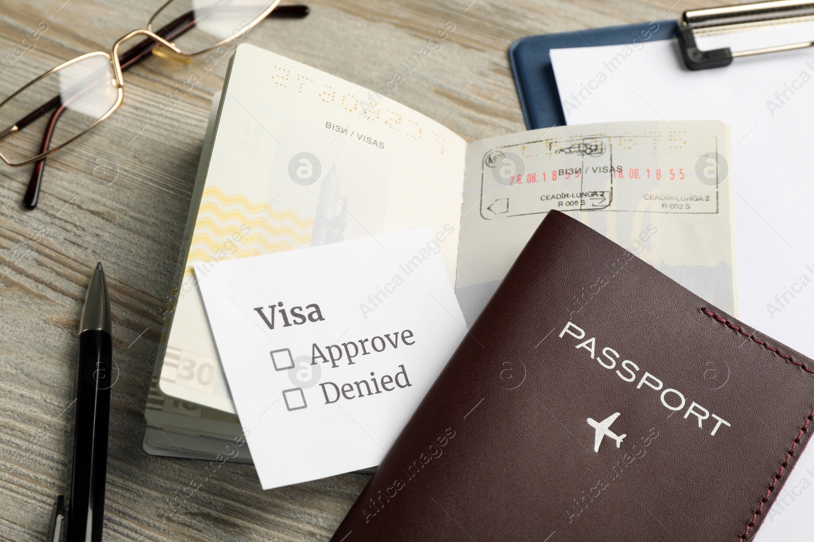 Photo of Moldova, Ceadir-Lunga - June 13, 2022: Passports with visa stamps on wooden table