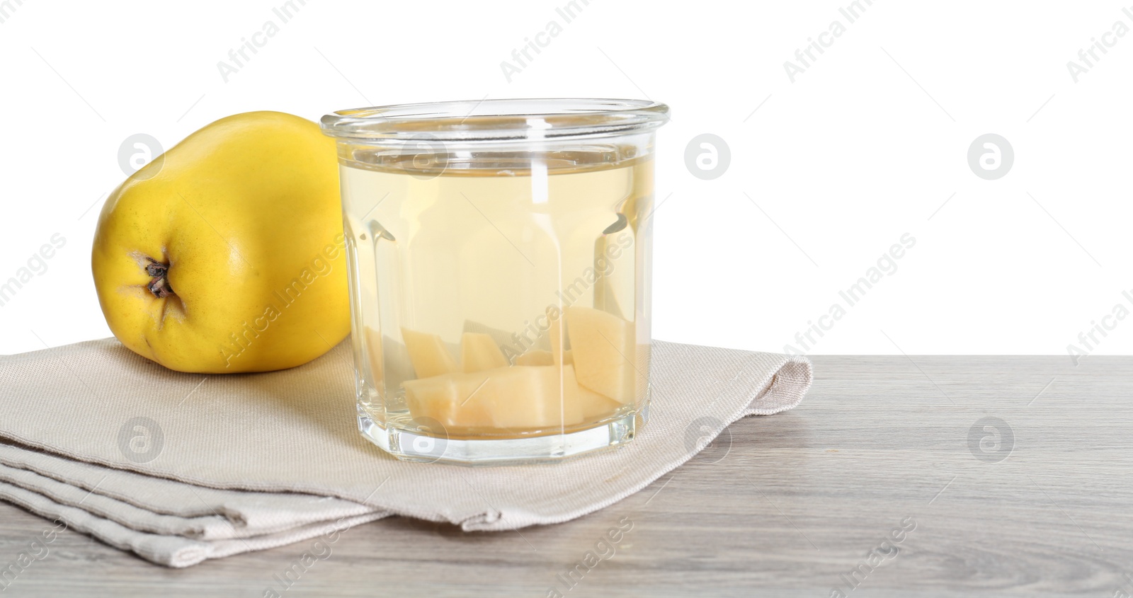 Photo of Delicious quince drink and fresh fruit on wooden table against white background