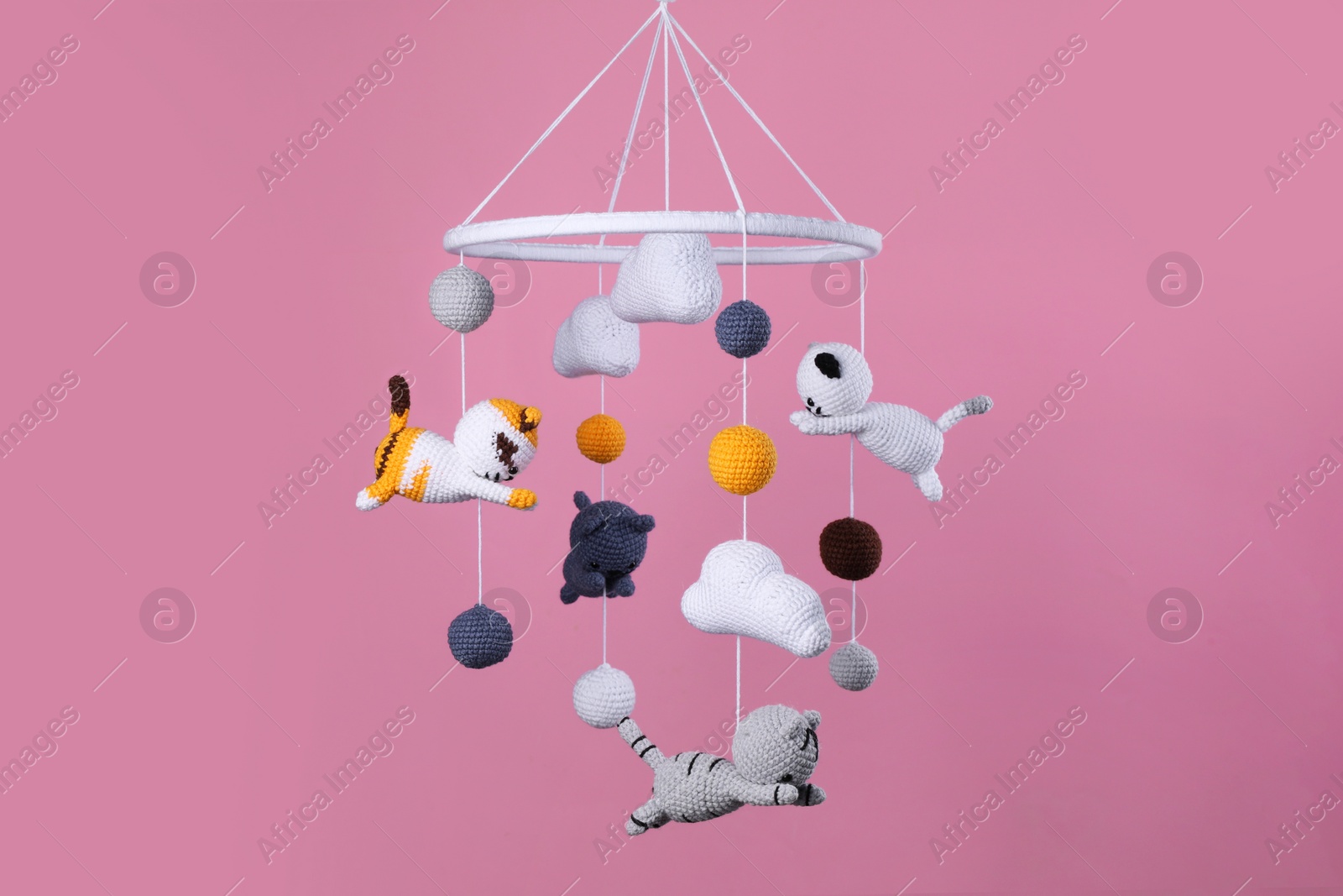 Photo of Cute baby crib mobile on pink background