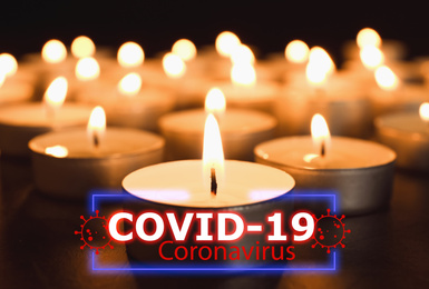 Funeral ceremony devoted to coronavirus victims. Burning candles on table 