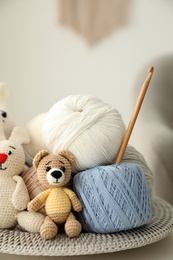 Photo of Toys, clews and crochet on table. Engaging in hobby