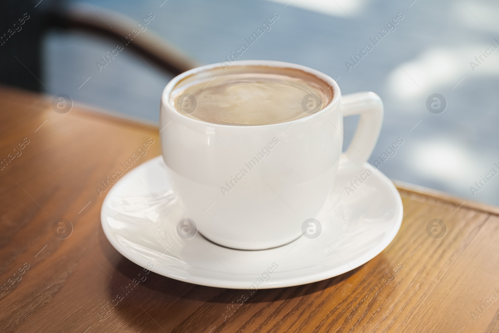 Photo of Aromatic coffee on wooden table outdoors, closeup