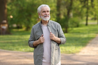 Photo of Portrait of happy grandpa in spring park