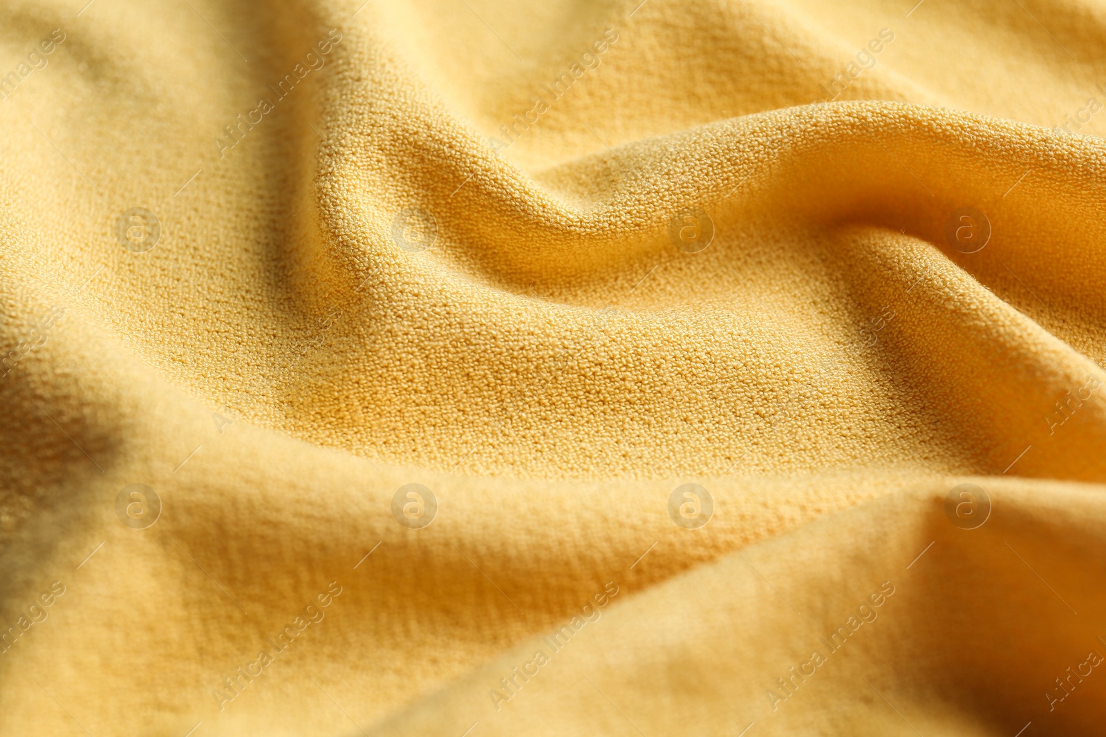 Photo of Texture of beautiful yellow fabric as background, closeup