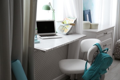 Comfortable workplace with laptop on window sill at home