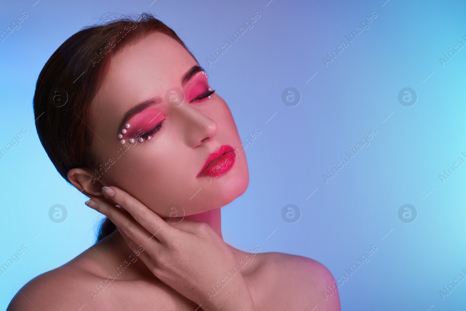 Photo of Fashionable portrait of beautiful young woman posing on colorful background. Space for text