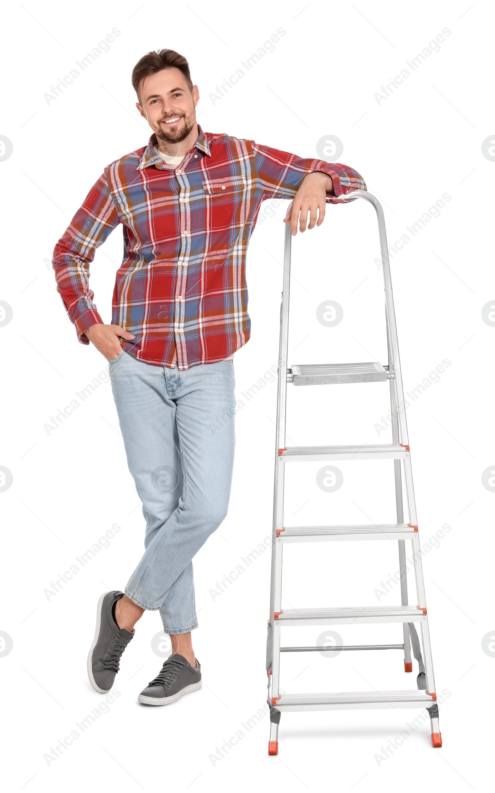 Photo of Young handsome man near metal ladder on white background