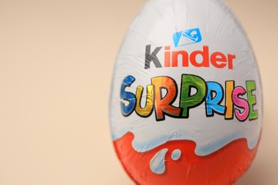 Slynchev Bryag, Bulgaria - May 25, 2023: Kinder Surprise Egg on beige background, closeup. Space for text