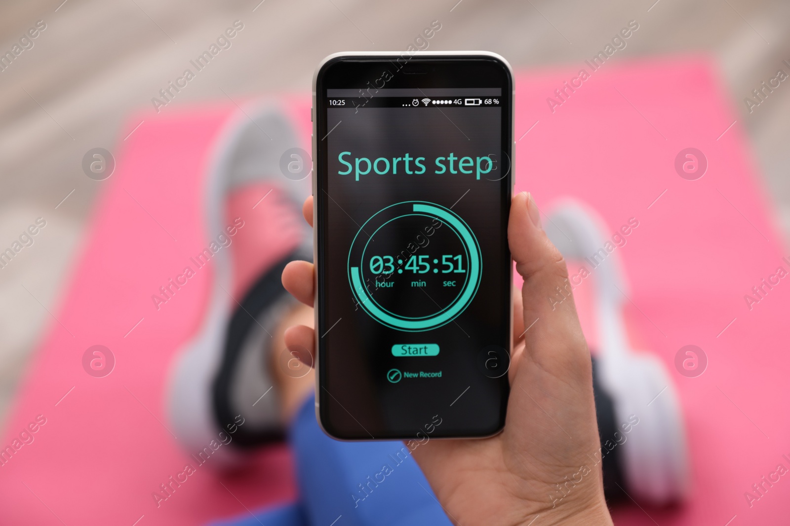 Photo of Young woman using fitness app on smartphone indoors, closeup