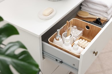 Photo of Different bath accessories and personal care products in drawer indoors