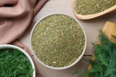 Dried and fresh dill on wooden table, flat lay