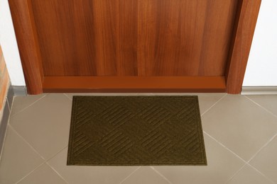 Clean door mat on floor near entrance