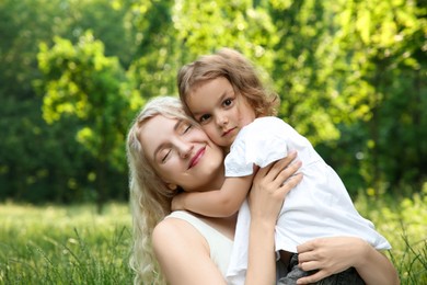 Photo of Portrait of beautiful mother with her cute daughter outdoors