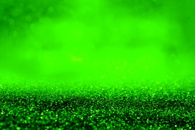 Image of St. Patrick day. Shiny green glitter, closeup. Bokeh effect