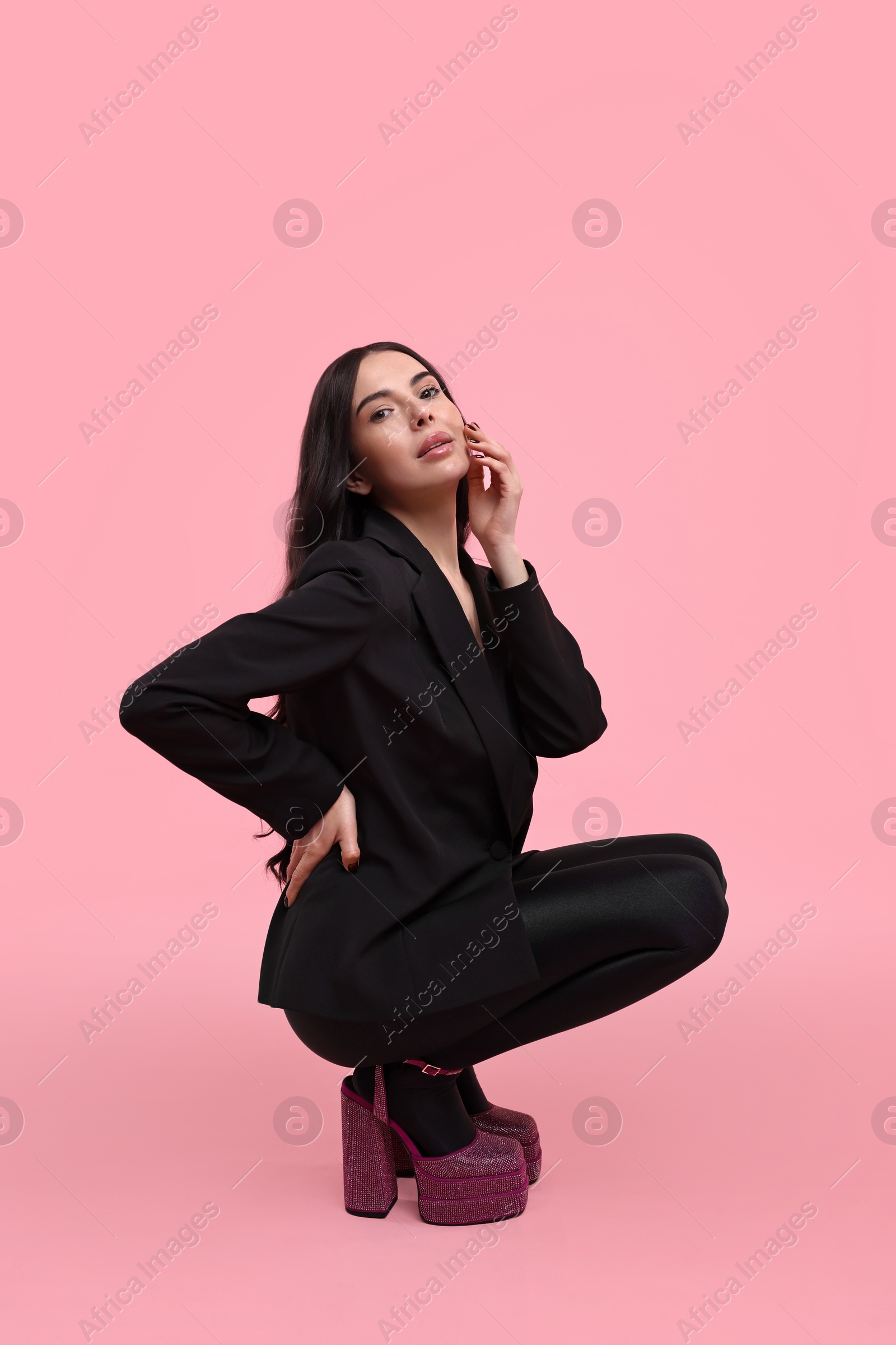 Photo of Stylish woman in black jacket on pink background