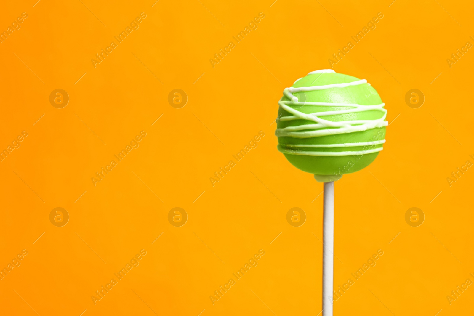 Photo of Bright delicious cake pop on color background. Space for text