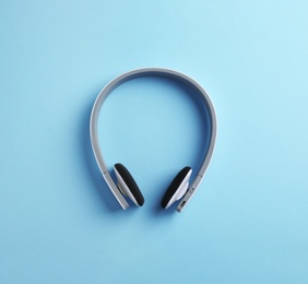 Photo of Wireless headphones on color background, top view