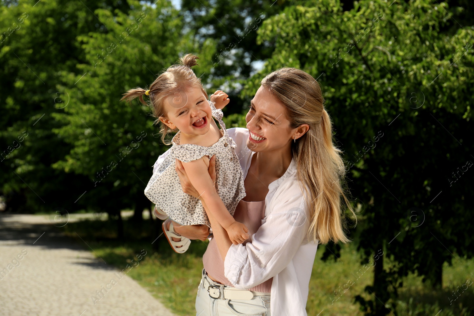 Photo of Happy mother with her daughter having fun in park