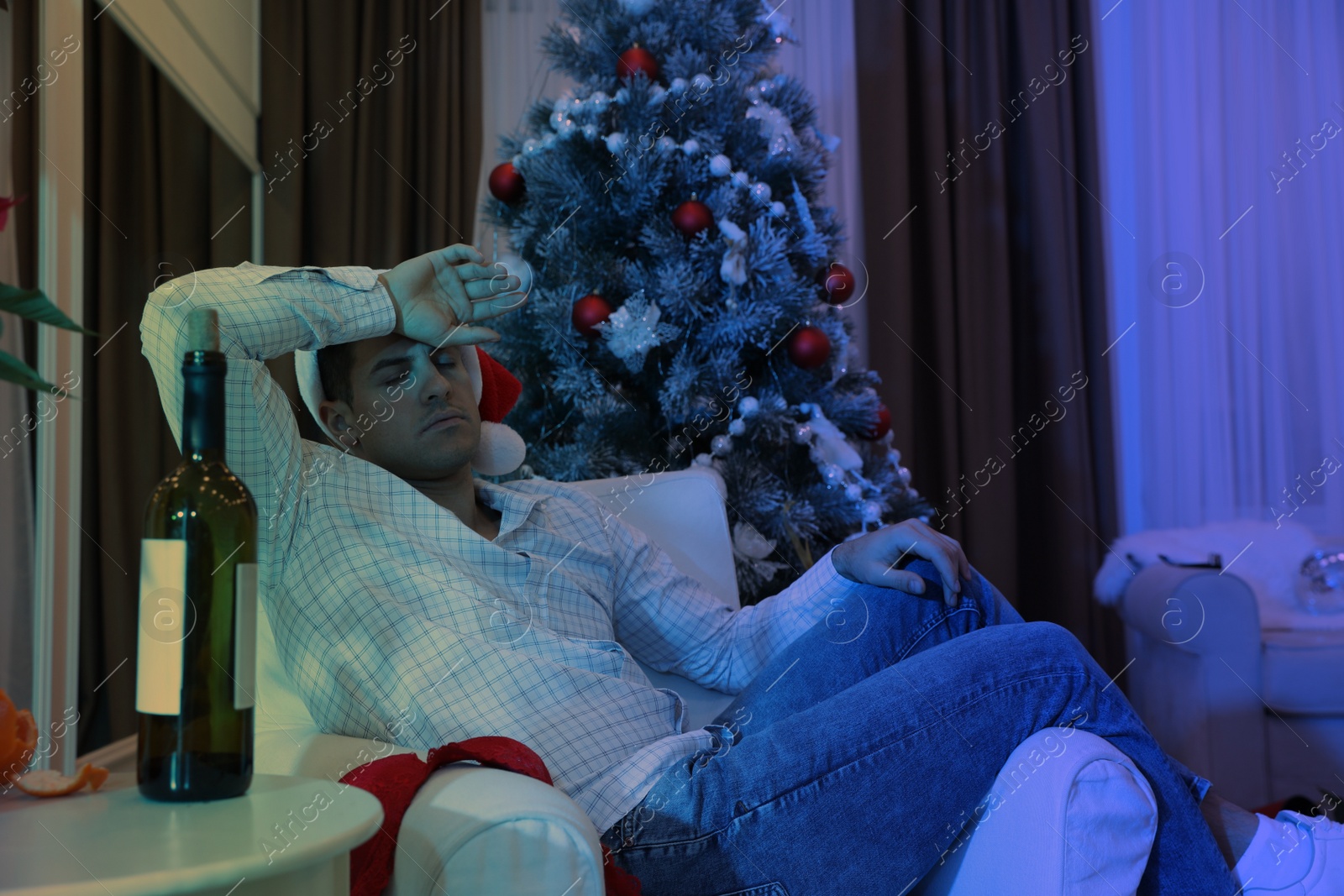 Photo of Man sleeping in messy room after New Year party