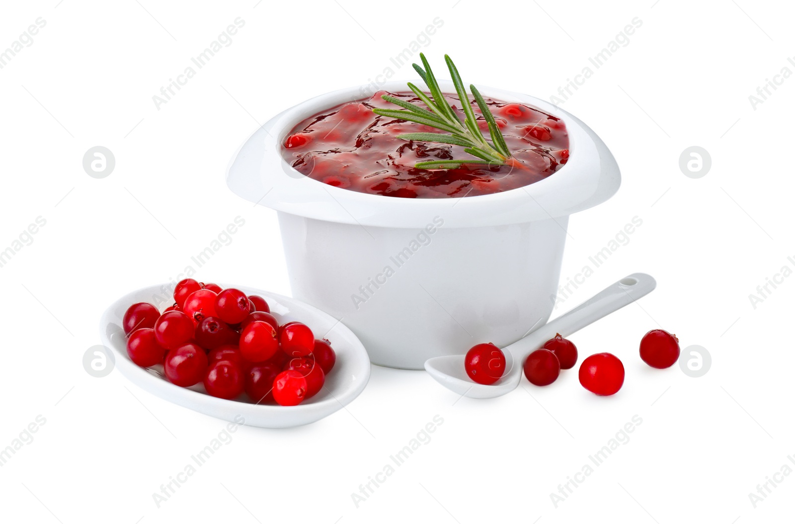 Photo of Cranberry sauce in bowl, fresh berries, spoon and rosemary isolated on white