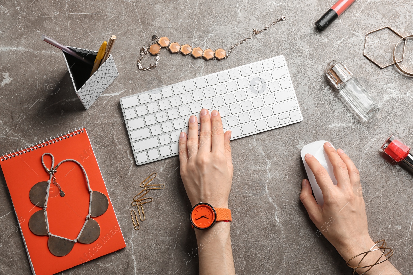 Photo of Blogger typing on keyboard at workplace, top view