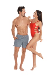 Photo of Young attractive couple in beachwear on white background