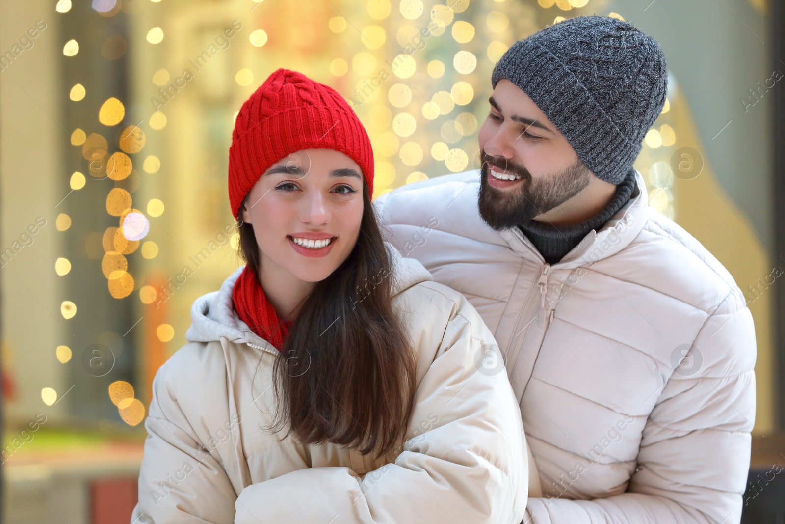 Photo of Portrait of lovely couple outdoors against blurred lights outdoors