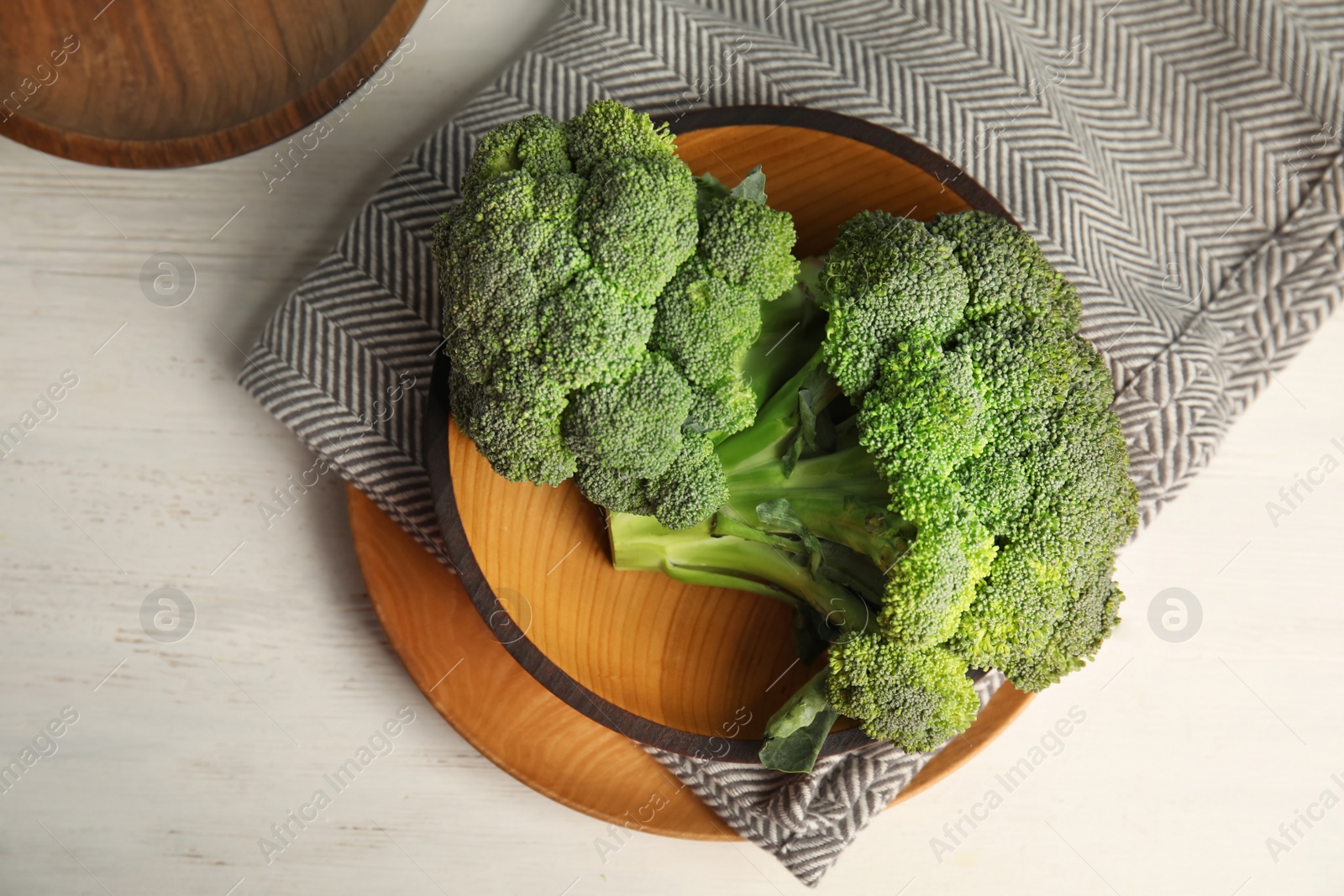 Photo of Plates with fresh broccoli on table, top view. Types of cabbage